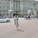 Nicole in front of the grand front gates of Buckingham Palace